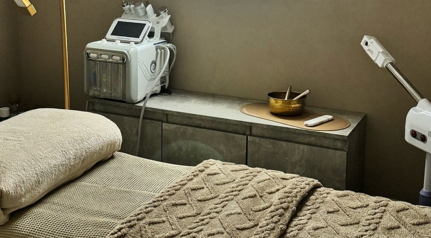 Relaxing treatment room at The Avenue, Epping, England, GB, featuring massage bed and modern equipment.