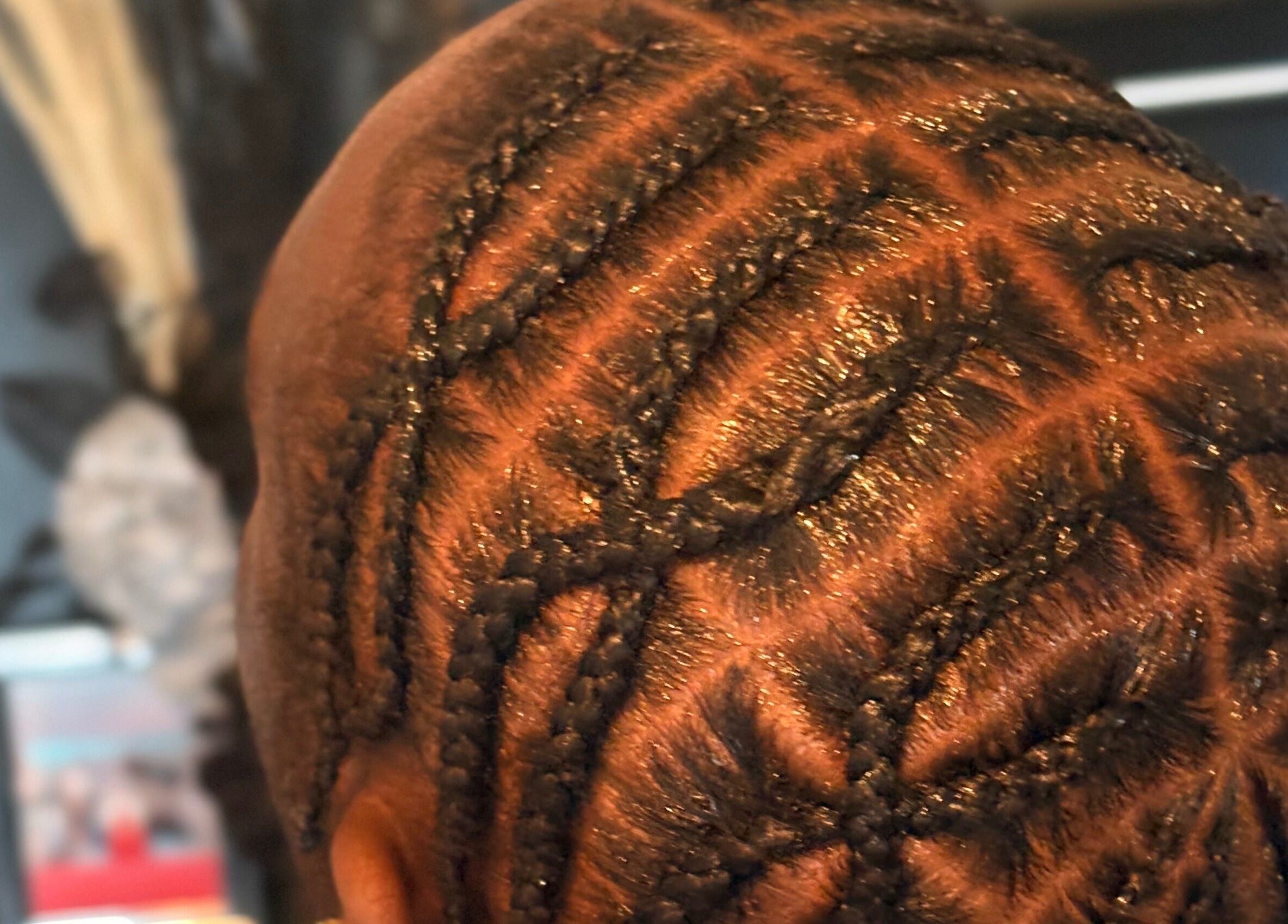 Close-up of intricate cornrow hairstyle at Styled by Kash, Leeds, England, GB.