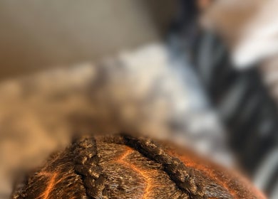Intricately styled braids at Styled by Kash in Leeds, England, GB, showcasing expert hair craftsmanship.