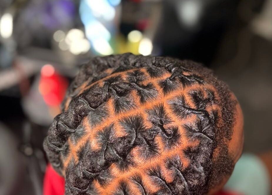 Close-up of intricate braid pattern by Styled by Kash in Leeds, England, GB, highlighting expert styling.
