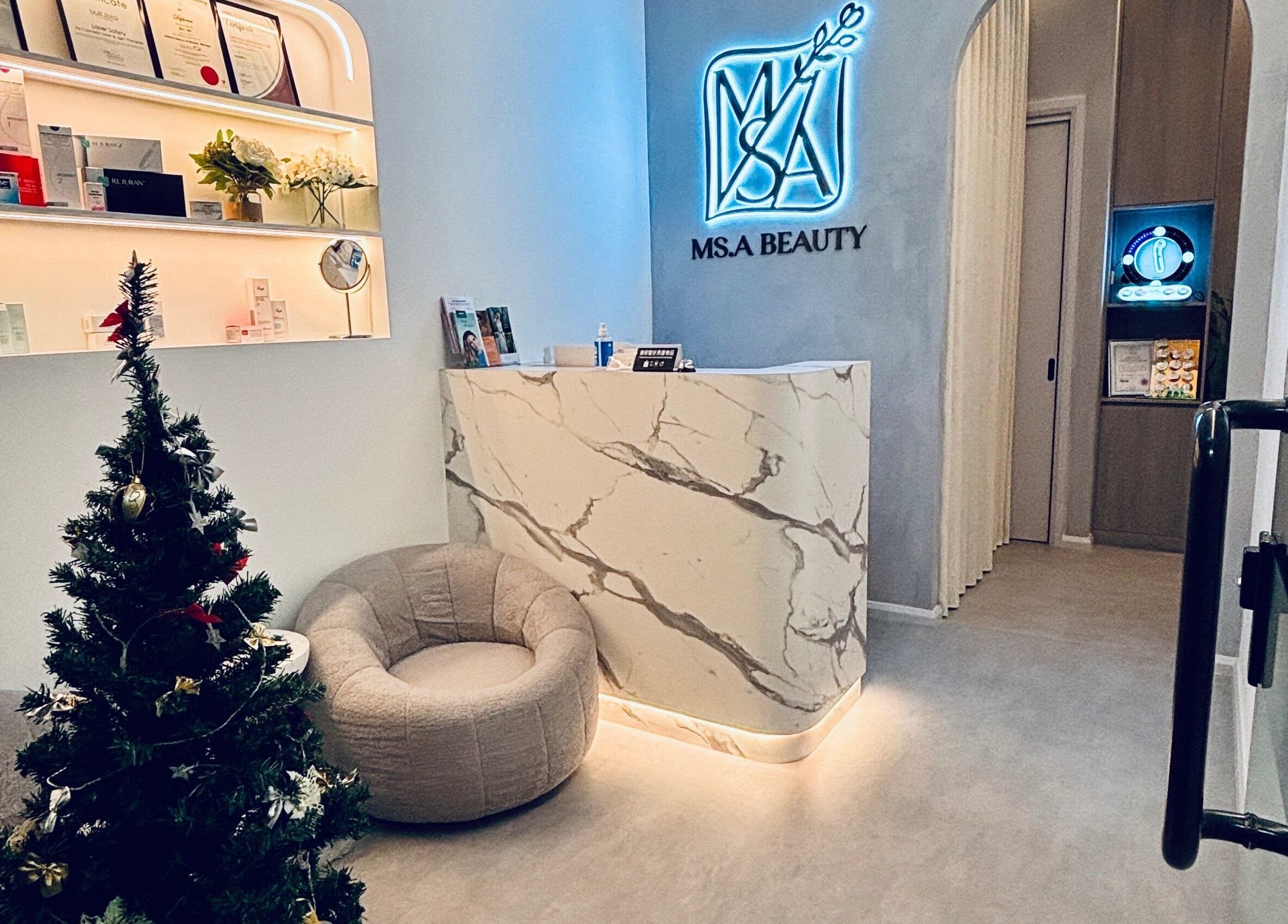 Elegant reception at Ms.A Beauty, Meadowbank, New South Wales, AU, with a chic marble desk and cozy seating.