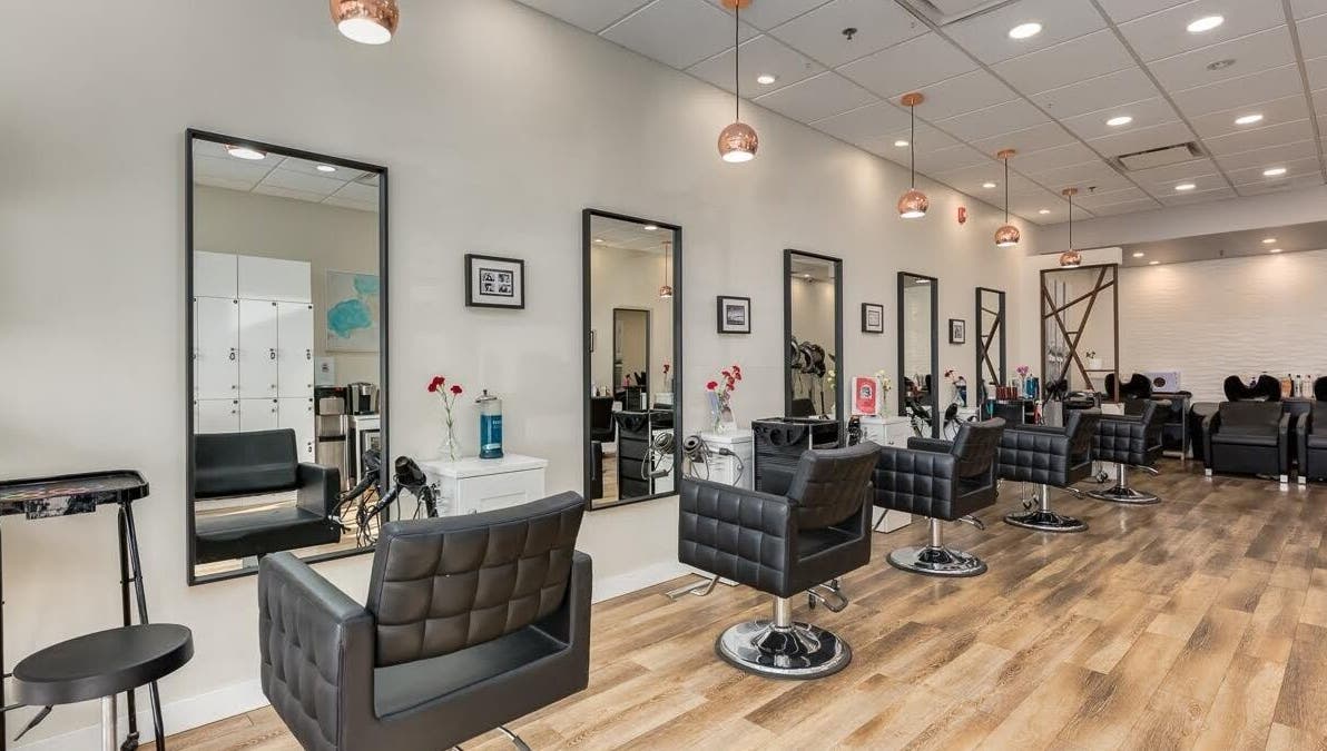 Modern interior of London Hair Salon Macleod Trail in Calgary, Alberta, CA featuring stylish chairs and mirrors.