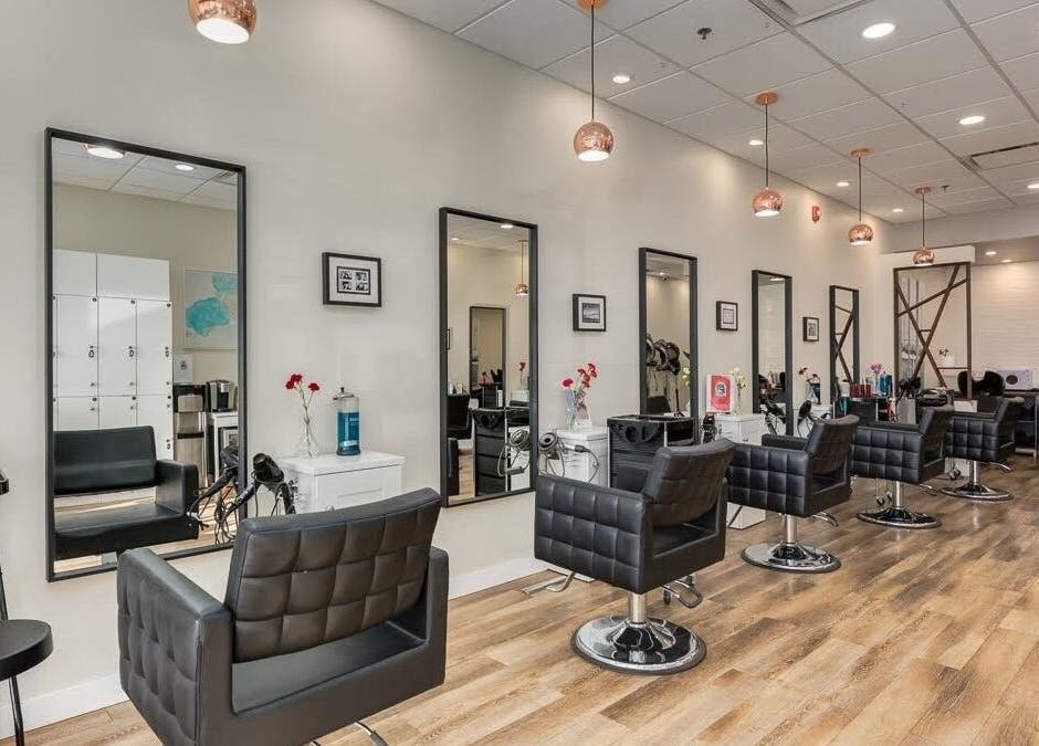 Modern interior of London Hair Salon Macleod Trail in Calgary, Alberta, CA featuring stylish chairs and mirrors.