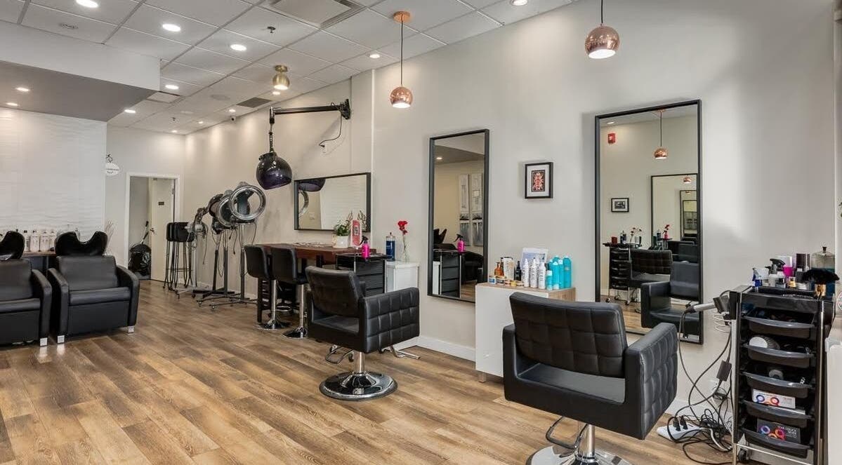 Spacious interior of London Hair Salon Macleod Trail, Calgary, Alberta, CA with modern chairs and mirrors.