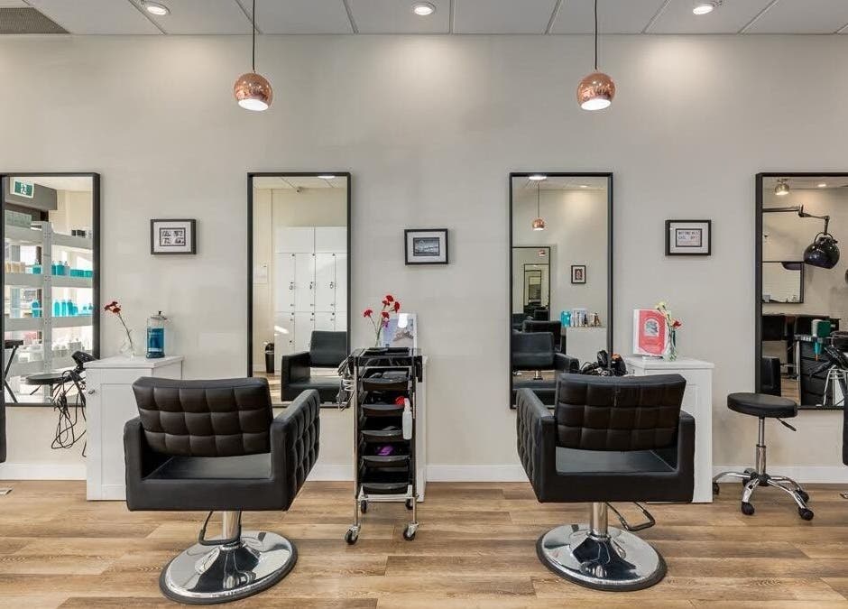 Modern interior of London Hair Salon Macleod Trail with stylish chairs in Calgary, Alberta, CA.