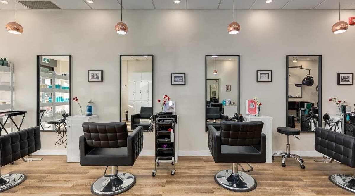 Modern interior of London Hair Salon Macleod Trail with stylish chairs in Calgary, Alberta, CA.