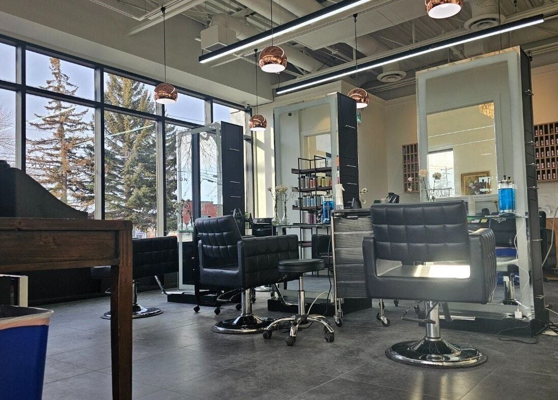 Modern interior of London Hair Salon Macleod Trail in Calgary, Alberta, CA with sleek styling chairs and equipment.
