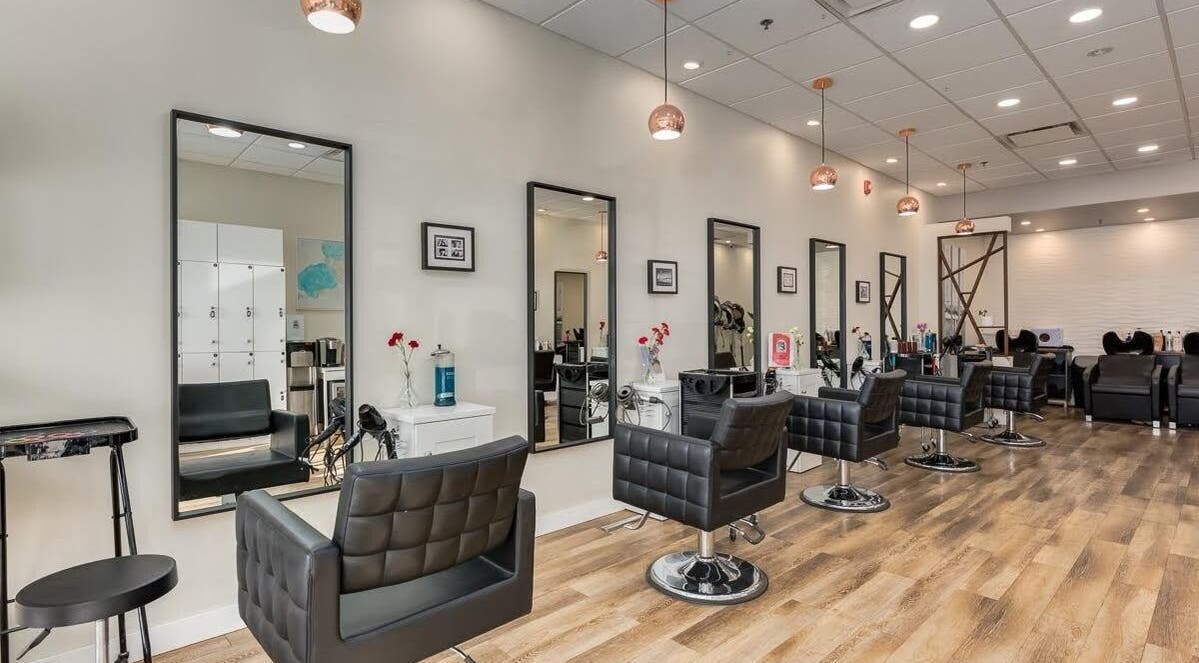 Modern salon interior at London Hair Salon Macleod Trail, Calgary, Alberta, CA featuring chic styling chairs.