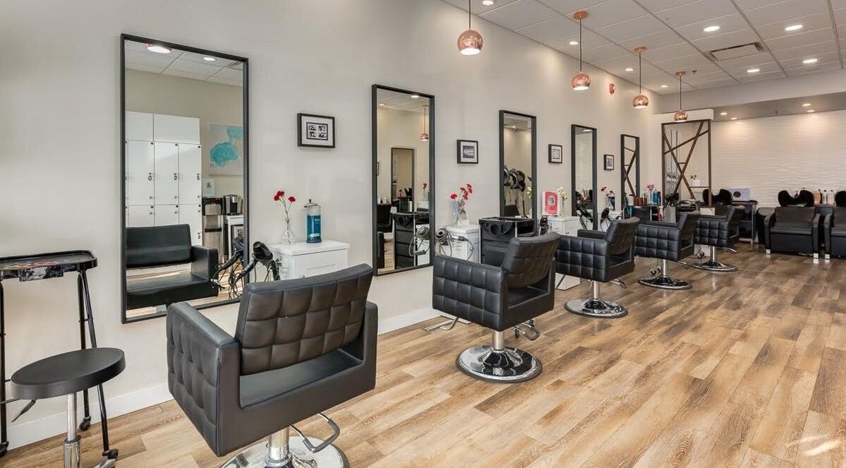 Interior of London Hair Salon Macleod Trail in Calgary, Alberta, CA with stylish salon chairs and mirrors.