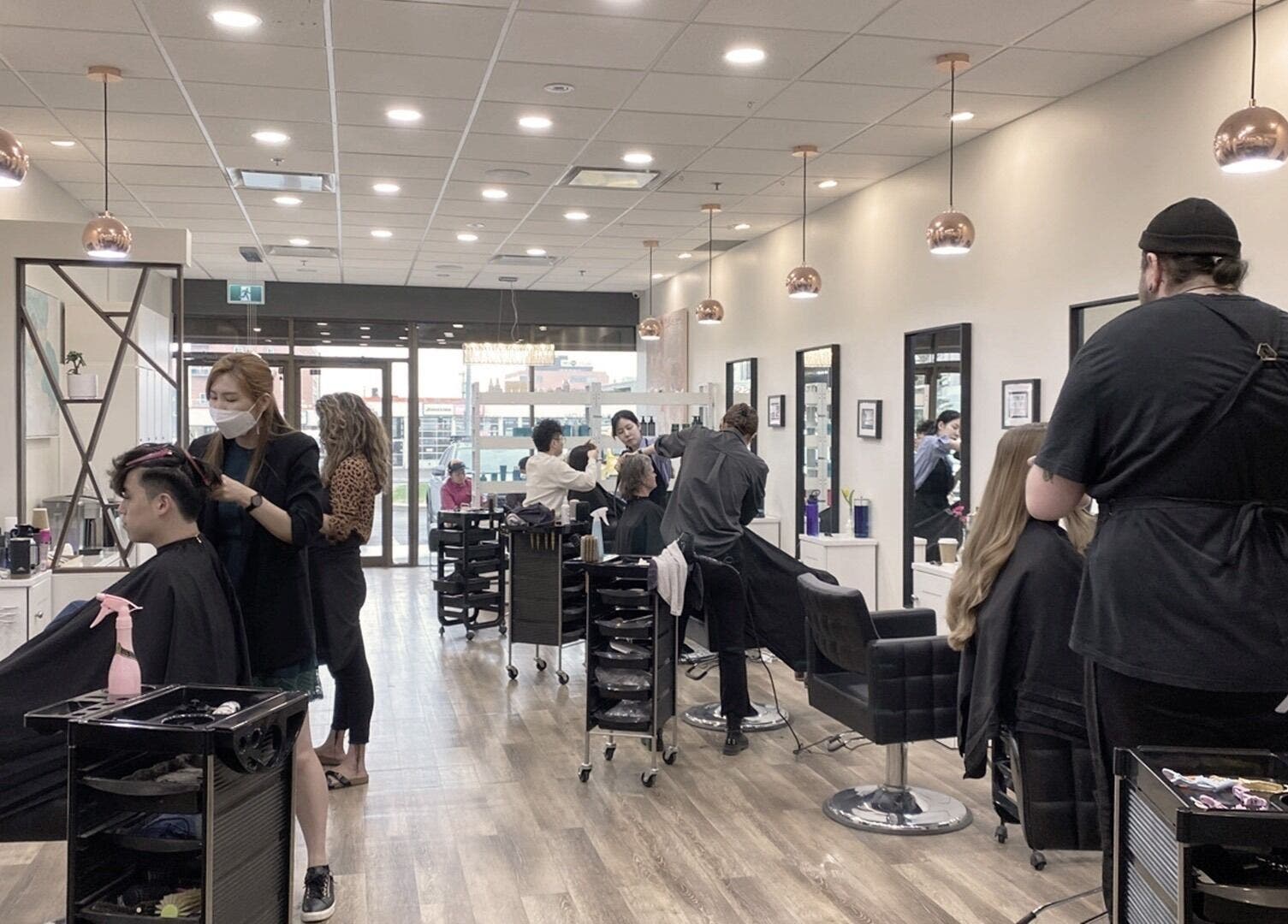 Stylish interior of London Hair Salon Macleod Trail, Calgary, Alberta, CA, showcasing client styling and modern decor.