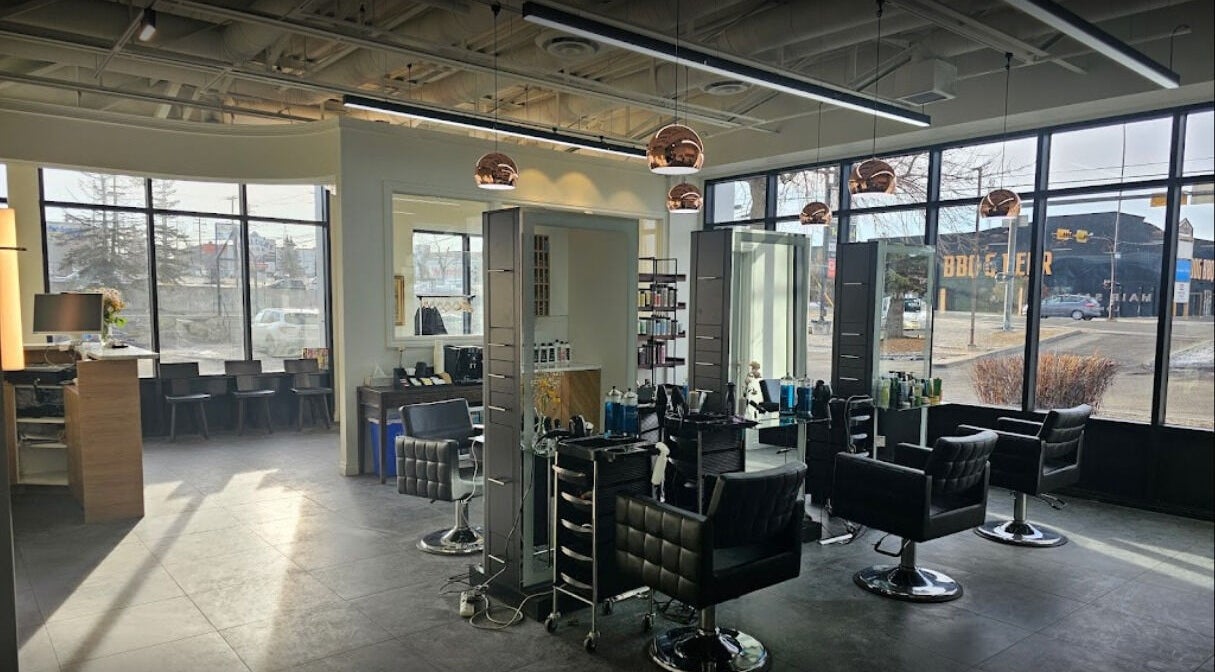 Spacious interior of London Hair Salon 58th Avenue in Calgary, Alberta, CA with modern decor and stylist chairs.