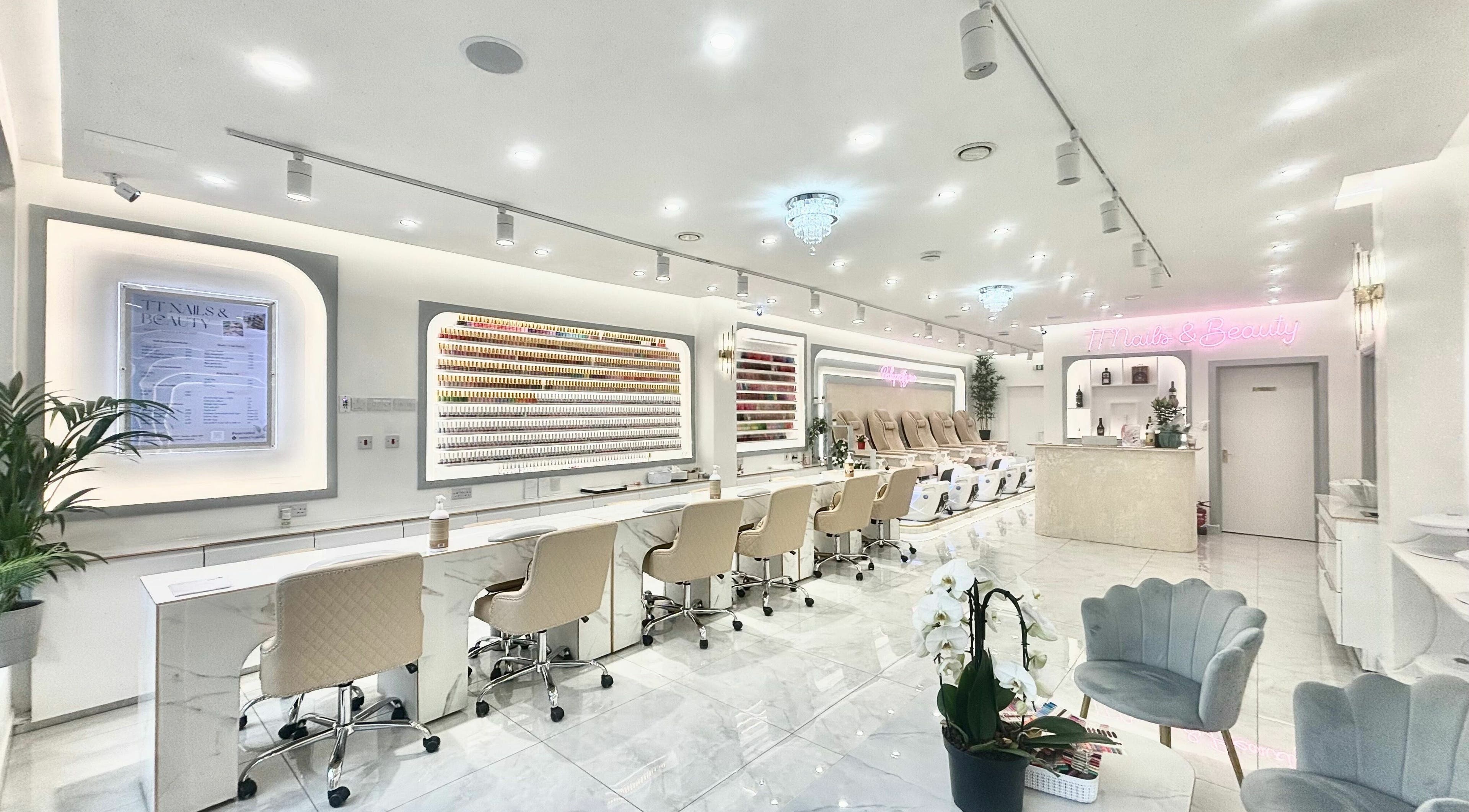 Spacious interior of TT Nails And Beauty Battersea in London, England, GB showcasing luxury nail stations.