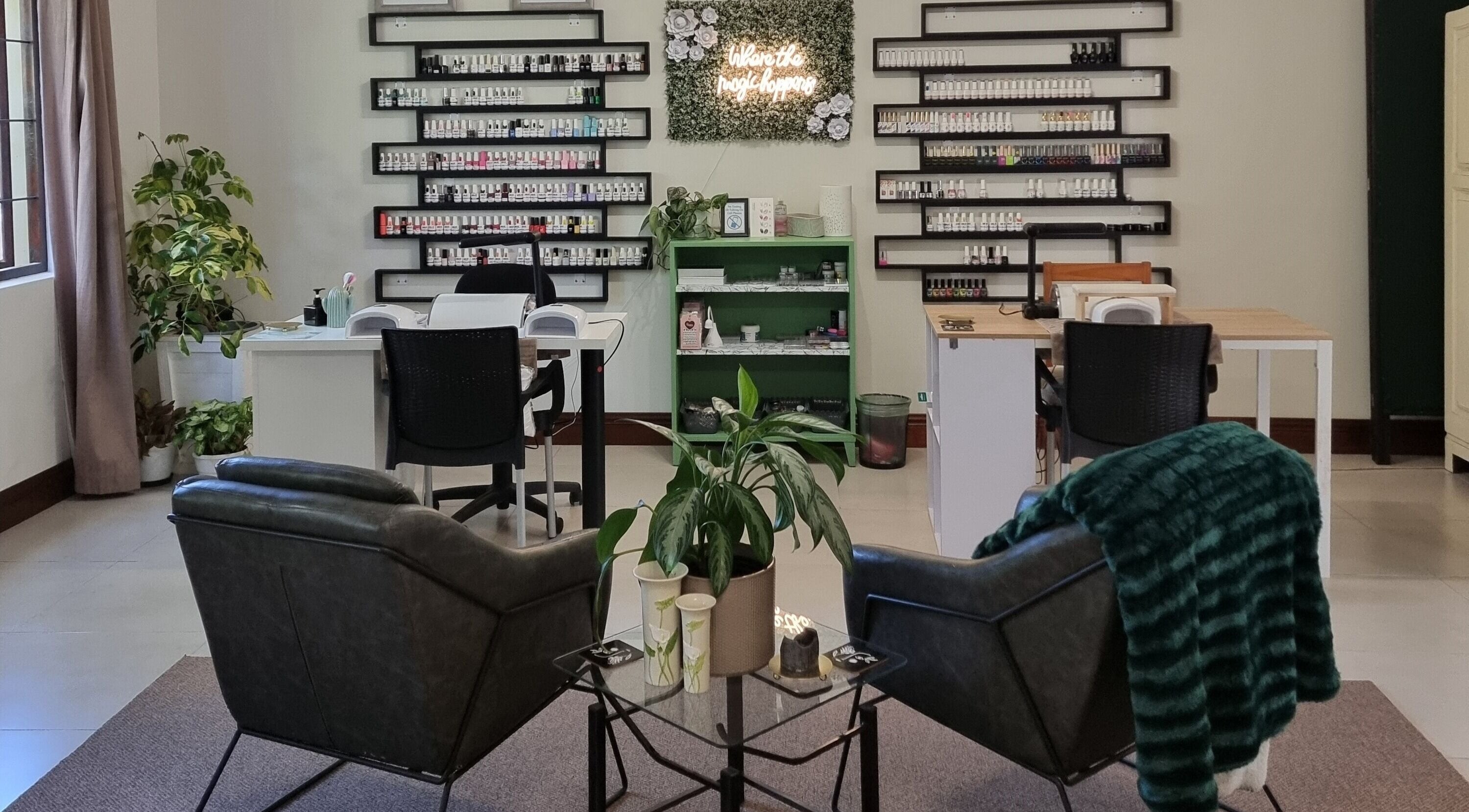 BeholdHer nail lounge in Gillitts, Kwazulu-natal, ZA, showcasing elegant seating and nail polish display.