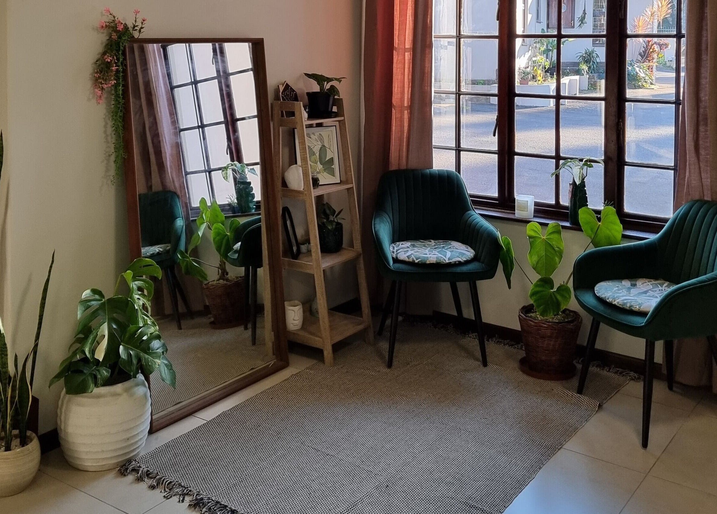 Cozy seating area with plants, mirror, and natural light at BeholdHer, Gillitts, Kwazulu-natal, ZA.
