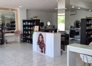 Spacious salon interior of The Hair Fairy in Estepona, Andalucía, ES showcasing stylish decor and beauty products.