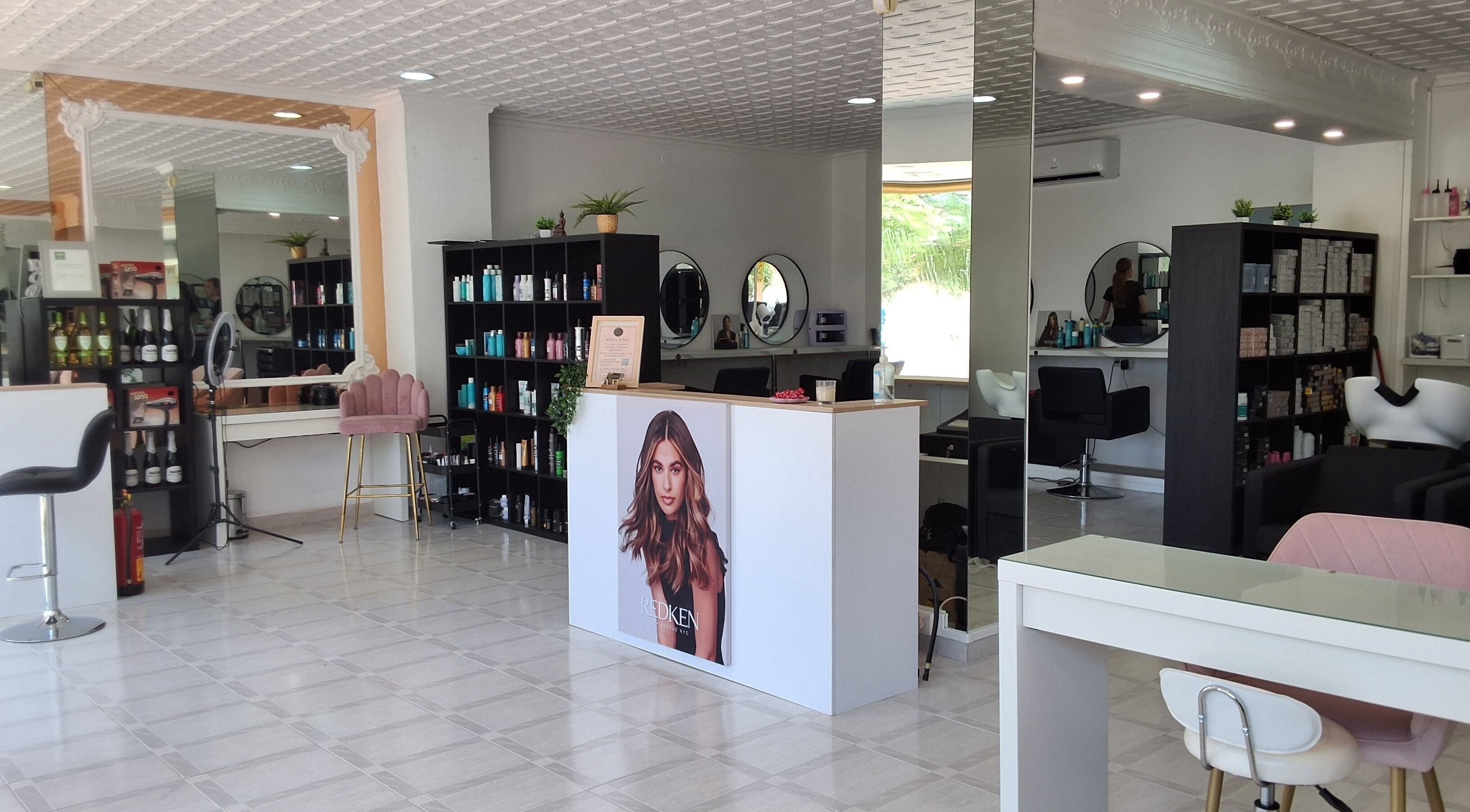 Spacious salon interior of The Hair Fairy in Estepona, Andalucía, ES showcasing stylish decor and beauty products.