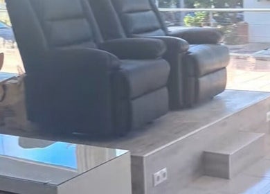 Comfortable black recliners at The Hair Fairy, Estepona, Andalucía, ES, offering relaxation and style.