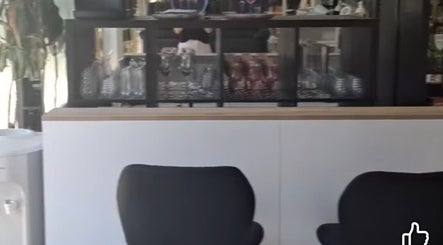 Trendy interior of The Hair Fairy in Estepona, Andalucía, ES with stylish barware display.