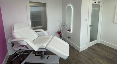 Modern treatment room at Pure Aesthetics by Tara, London, England, GB featuring a sleek white chair.