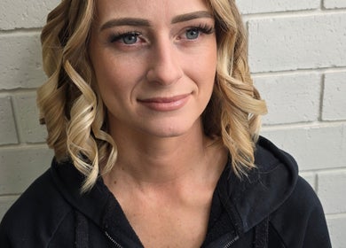 Blonde woman smiling, showcasing curls at Skin and Beauty by Leah, Nambucca Heads, New South Wales, AU.