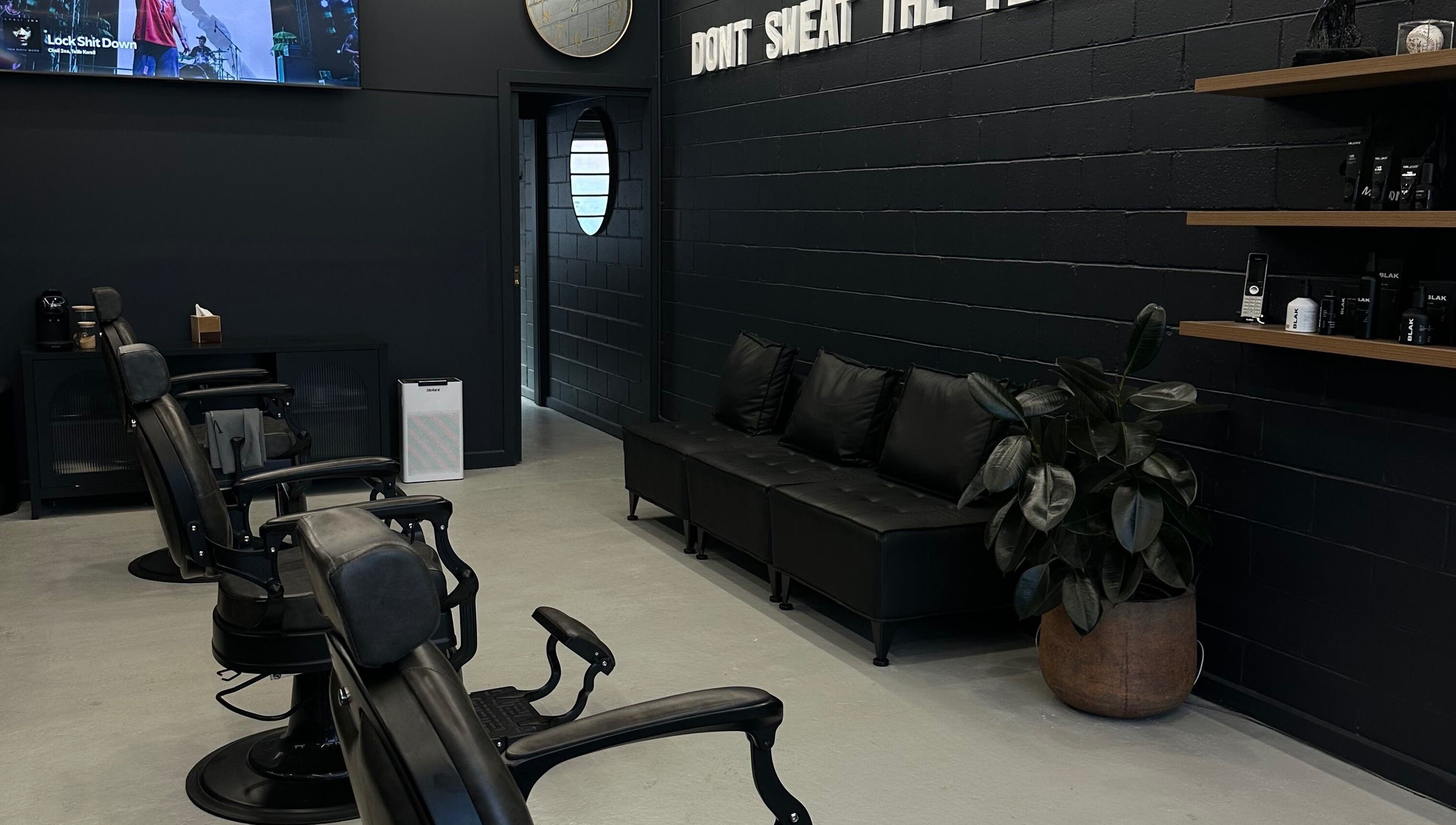 Modern interior of Virtuoso Black in Melbourne, Victoria, AU with sleek barber chairs and elegant decor.