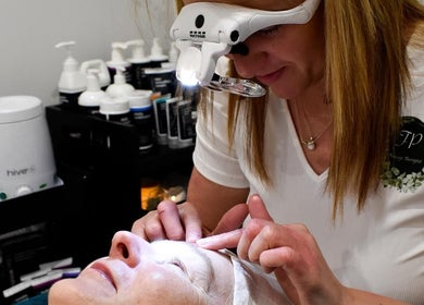 FP Massage Therapist at Chesterfield, England, GB performs a detailed facial treatment.