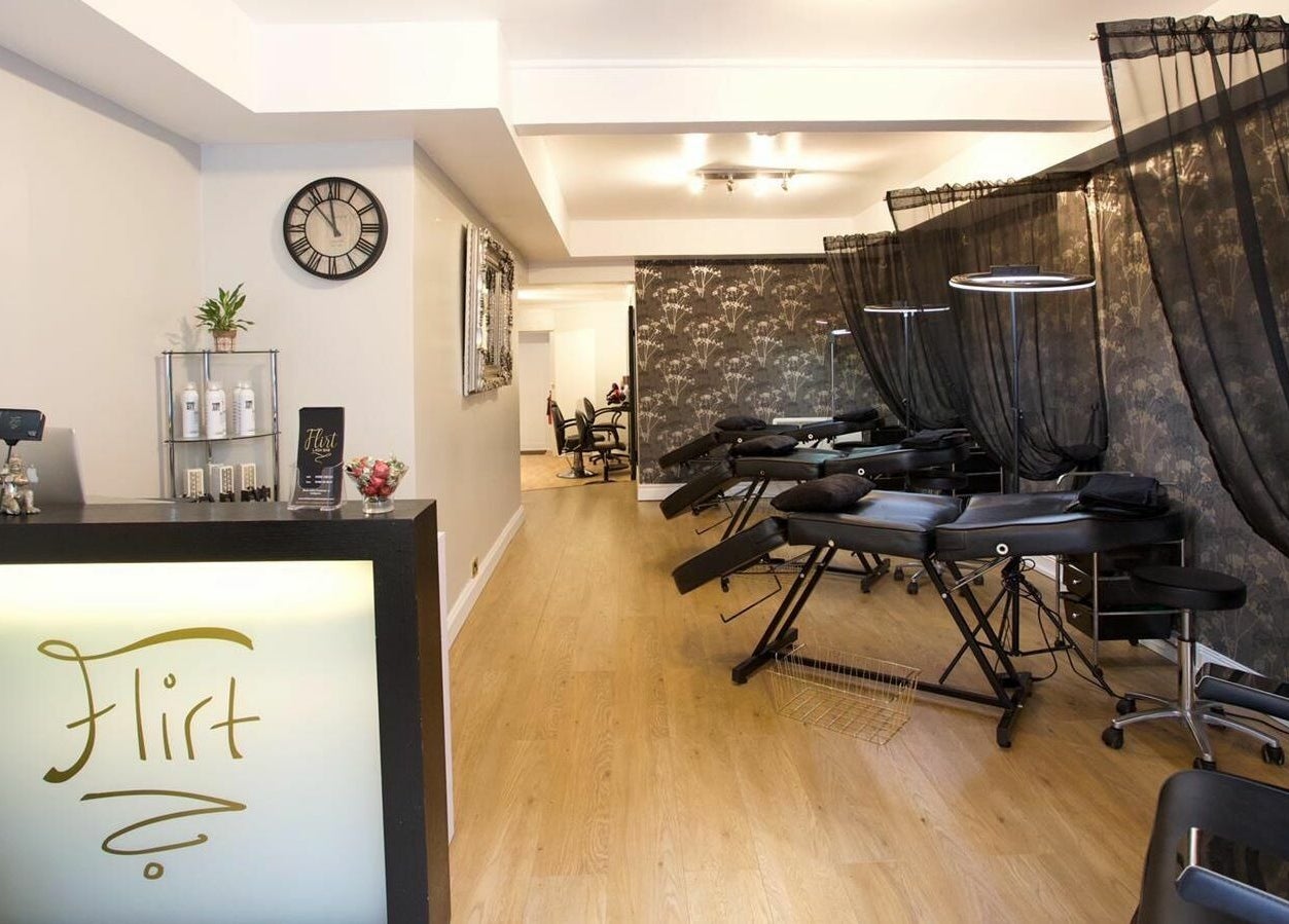 Spacious and elegant interior of Flirt Lash & Brow Bar in Leamington Spa, England, GB featuring treatment beds.