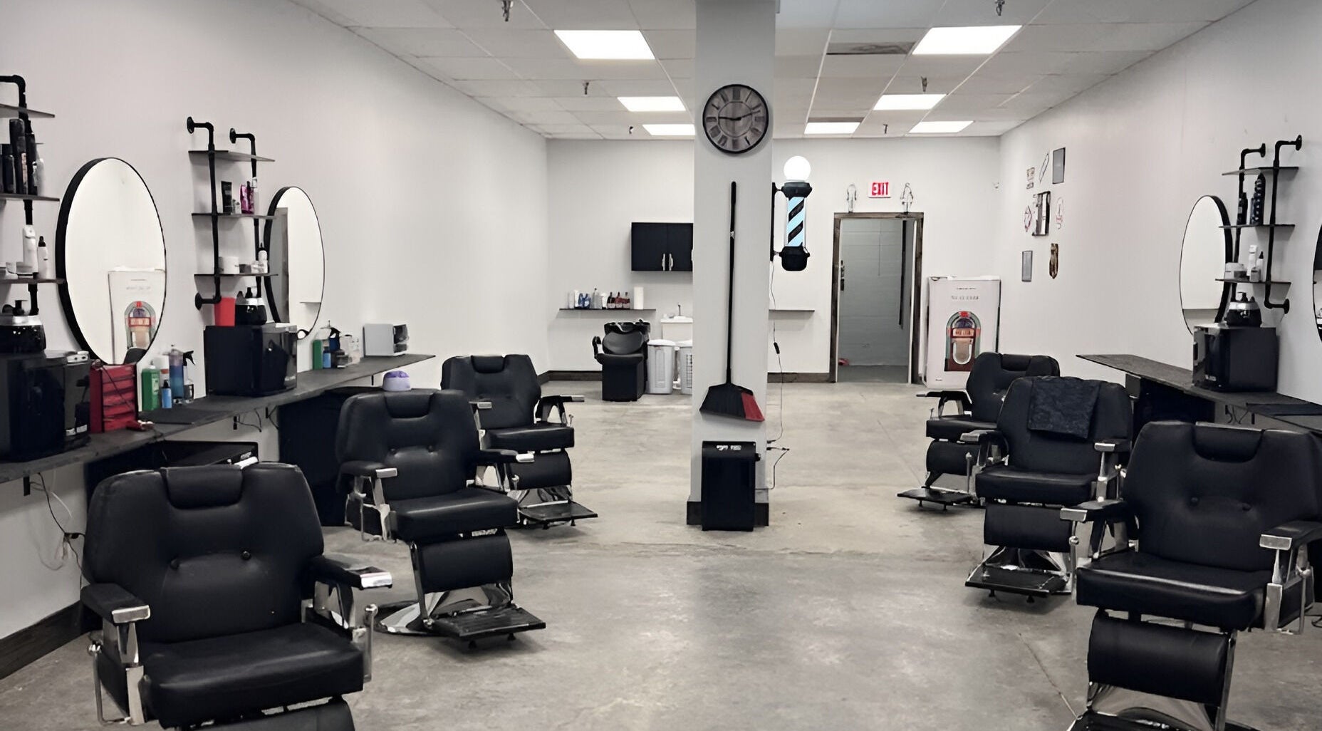Interior of J CO. Hair Cave Barbershop, Columbia, Tennessee with stylish black barber chairs.