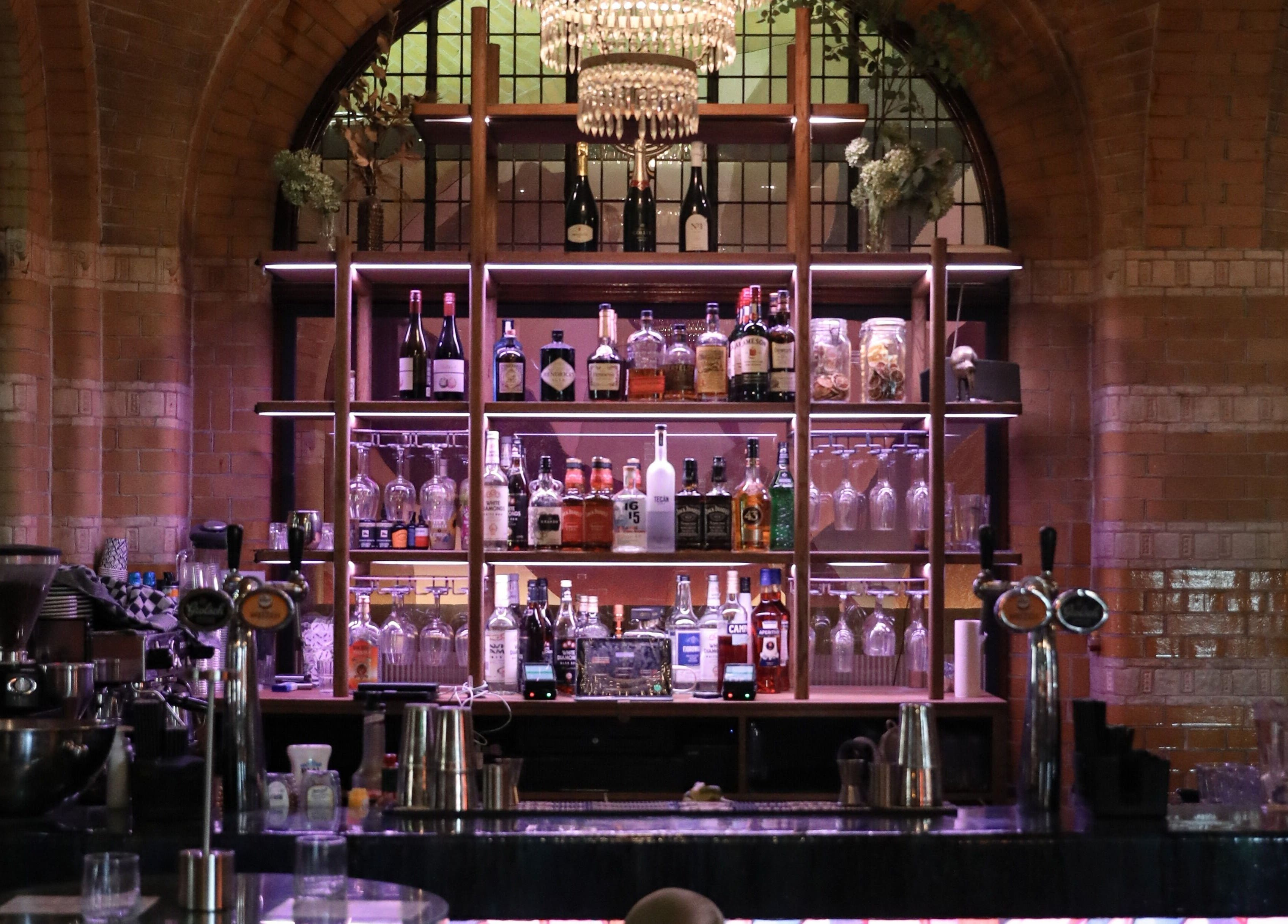 Chic bar setting at Cut Throat - Beursplein in Amsterdam, Noord-Holland, NL with elegant glassware and bottles.