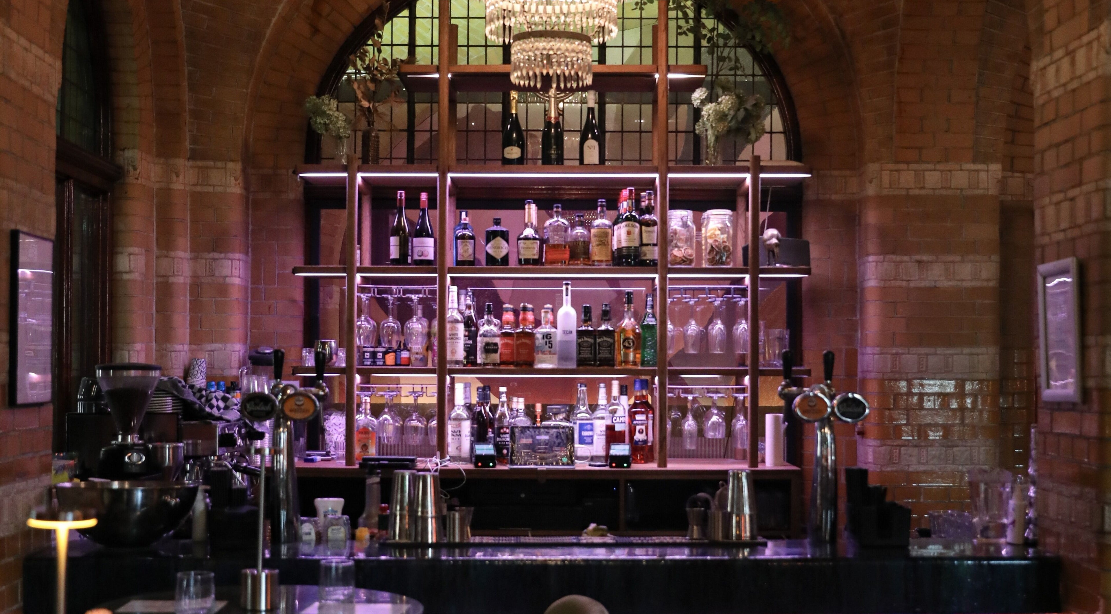 Chic bar setting at Cut Throat - Beursplein in Amsterdam, Noord-Holland, NL with elegant glassware and bottles.