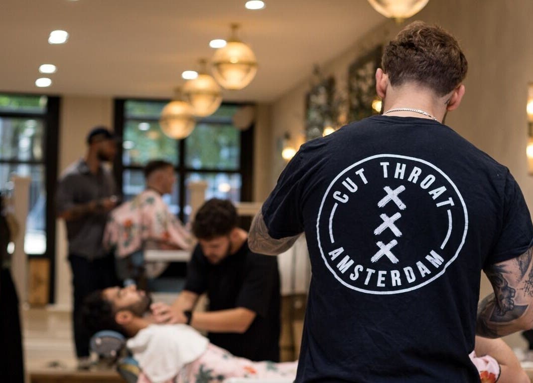 Cut Throat - De Pijp barber styling a client's hair in Amsterdam, Noord-Holland, NL.