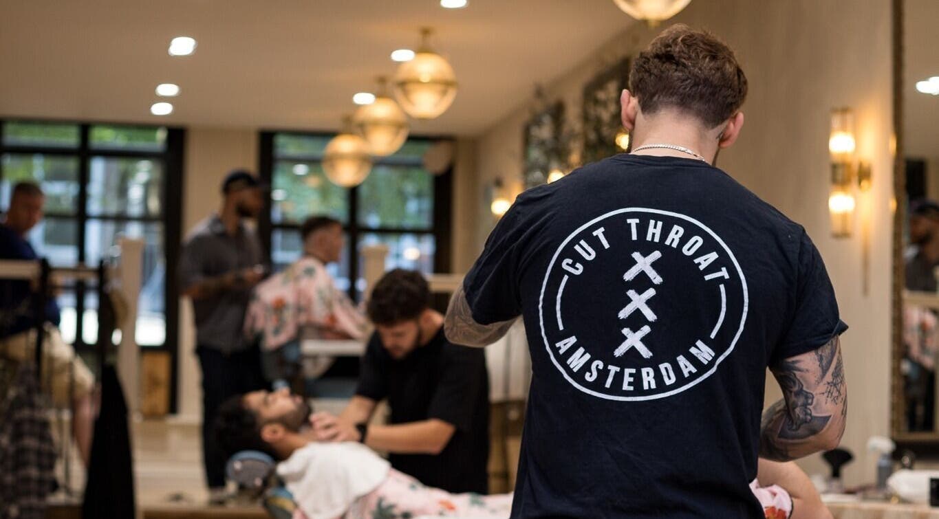 Cut Throat - De Pijp barber styling a client's hair in Amsterdam, Noord-Holland, NL.