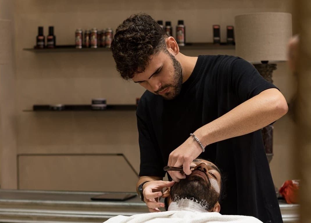 Barber performing precise grooming at Cut Throat - De Pijp, Amsterdam, Noord-Holland, NL.
