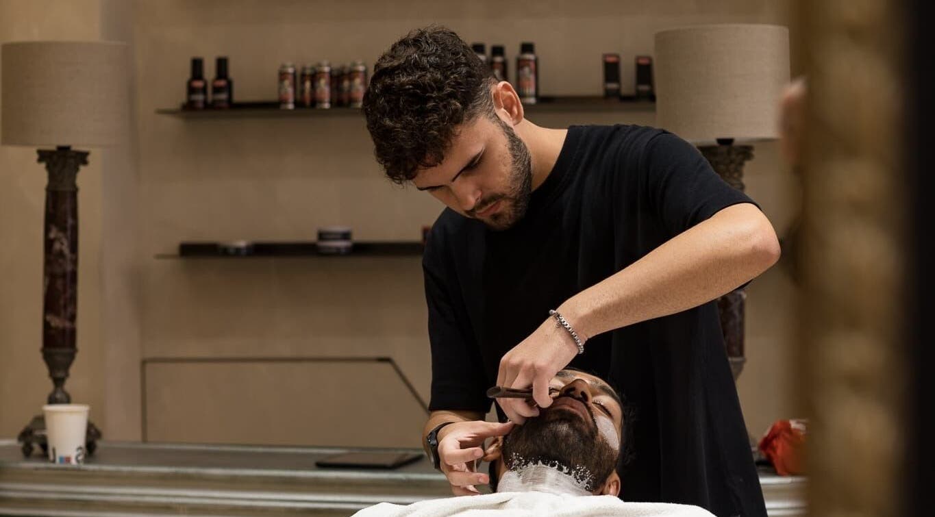 Barber performing precise grooming at Cut Throat - De Pijp, Amsterdam, Noord-Holland, NL.