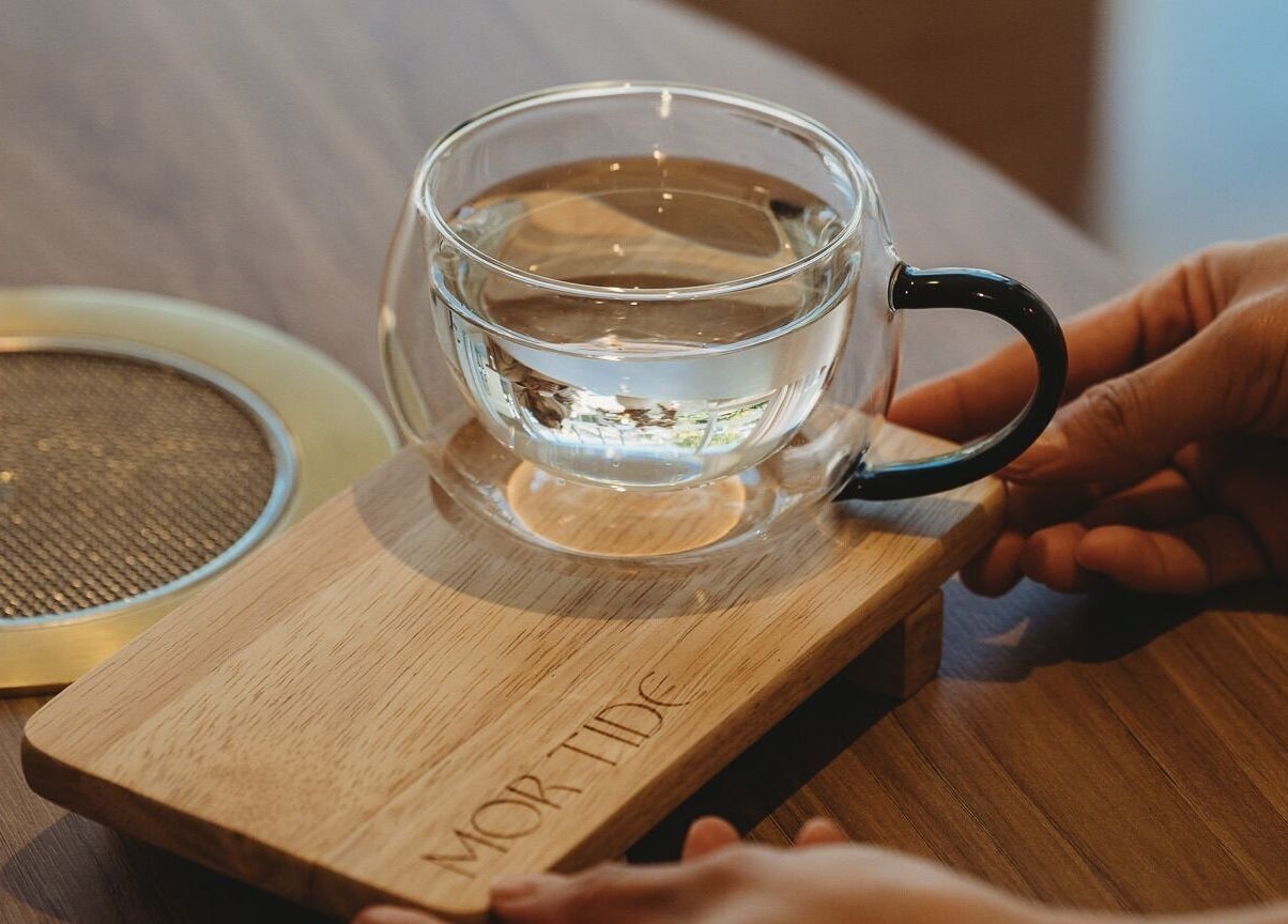 Glass teacup on a wooden tray at Mor Tide Day Spa, Fortitude Valley, Queensland, AU.
