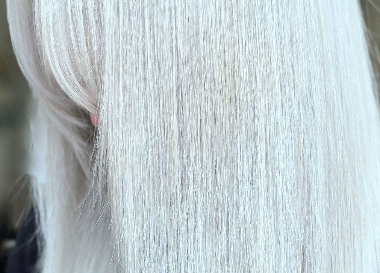 Smooth, straight platinum blonde hair styled at Kerry Carroll Hair Design (At JFK), Edinburgh, Scotland, GB.