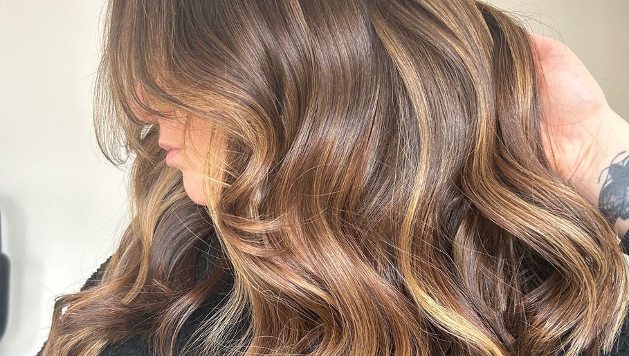 Glossy brown waves styled at Emma Conroy Hair in Widnes, England, GB, highlighting rich color and texture.