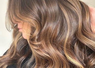 Glossy brown waves styled at Emma Conroy Hair in Widnes, England, GB, highlighting rich color and texture.