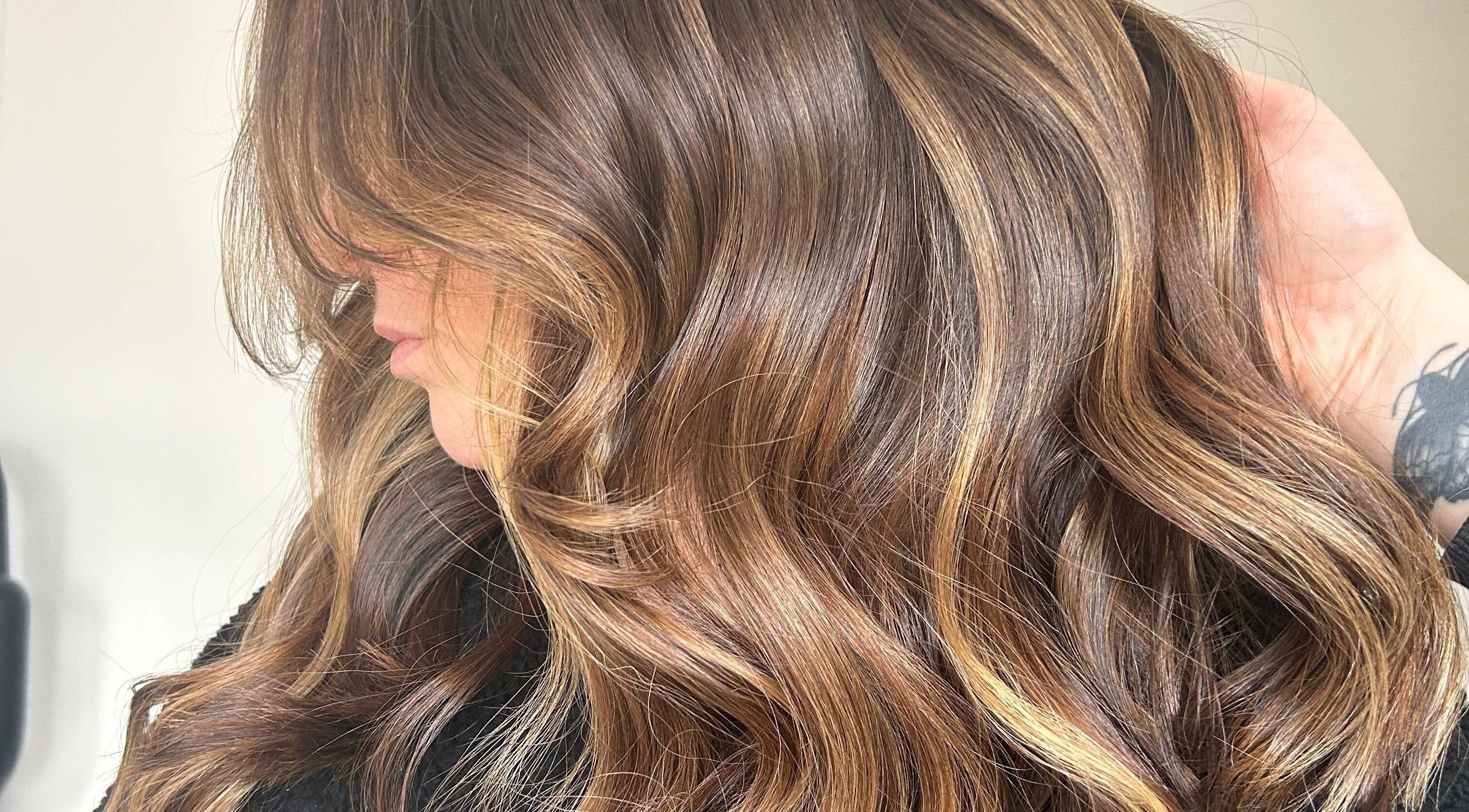 Glossy brown waves styled at Emma Conroy Hair in Widnes, England, GB, highlighting rich color and texture.