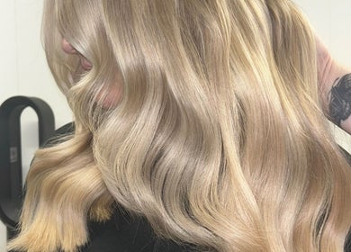 Blonde hair styled in soft waves at Emma Conroy Hair, Widnes, England, GB.