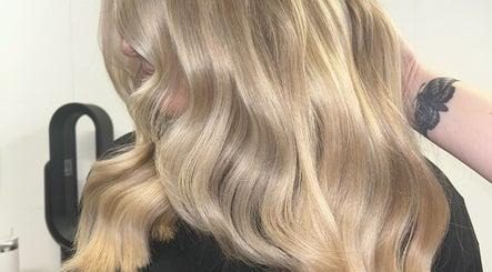 Blonde hair styled in soft waves at Emma Conroy Hair, Widnes, England, GB.