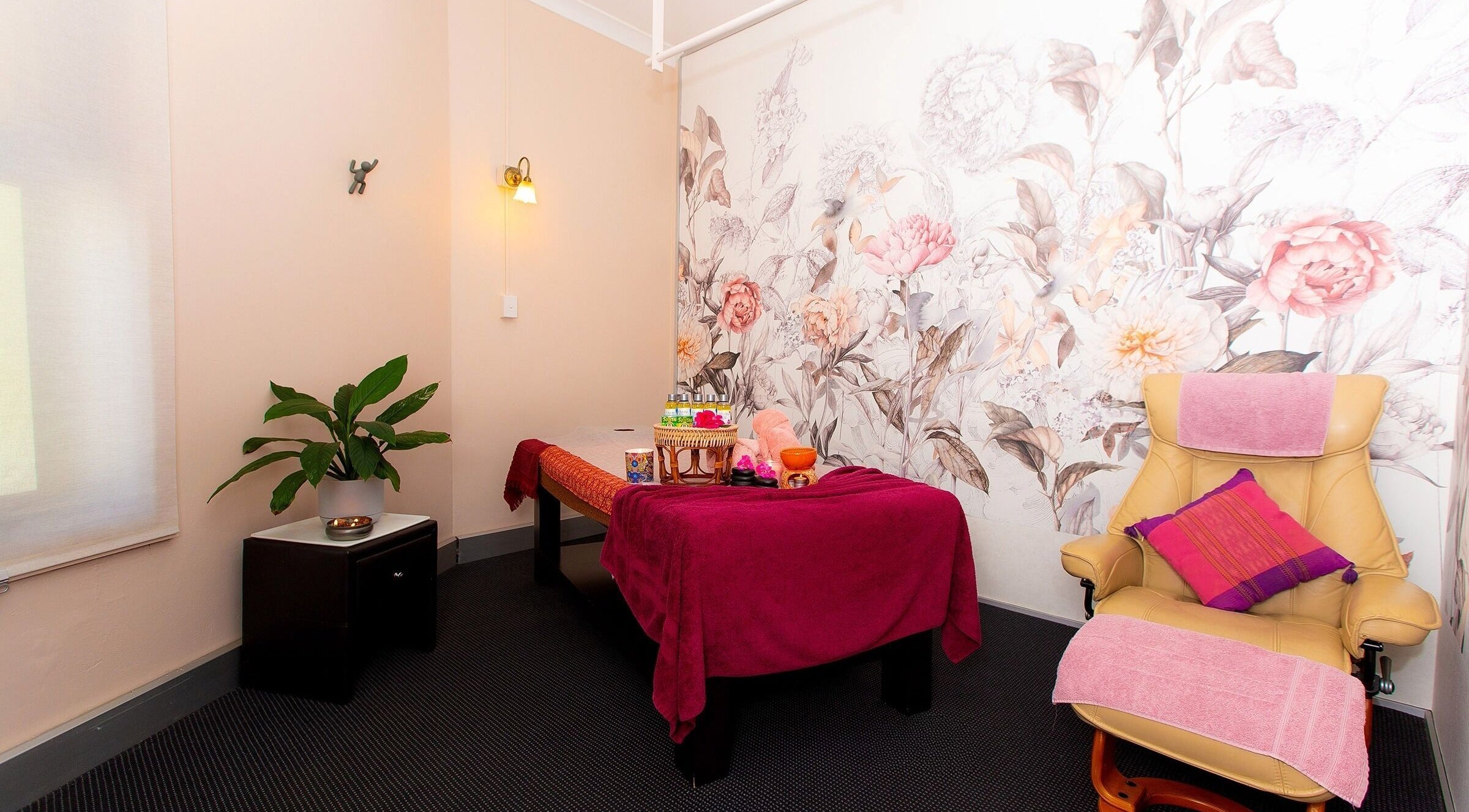 Relaxation room at Chat Thai Massage in Crows Nest, New South Wales, AU featuring floral decor and massage table.