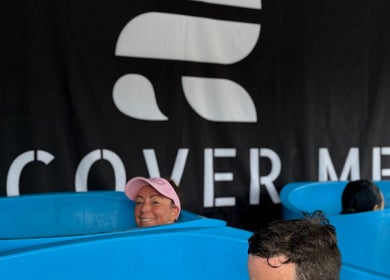 People in blue tubs relaxing at Fourtress 2025, Auckland, Auckland, NZ. Wellness experience with branded backdrop.