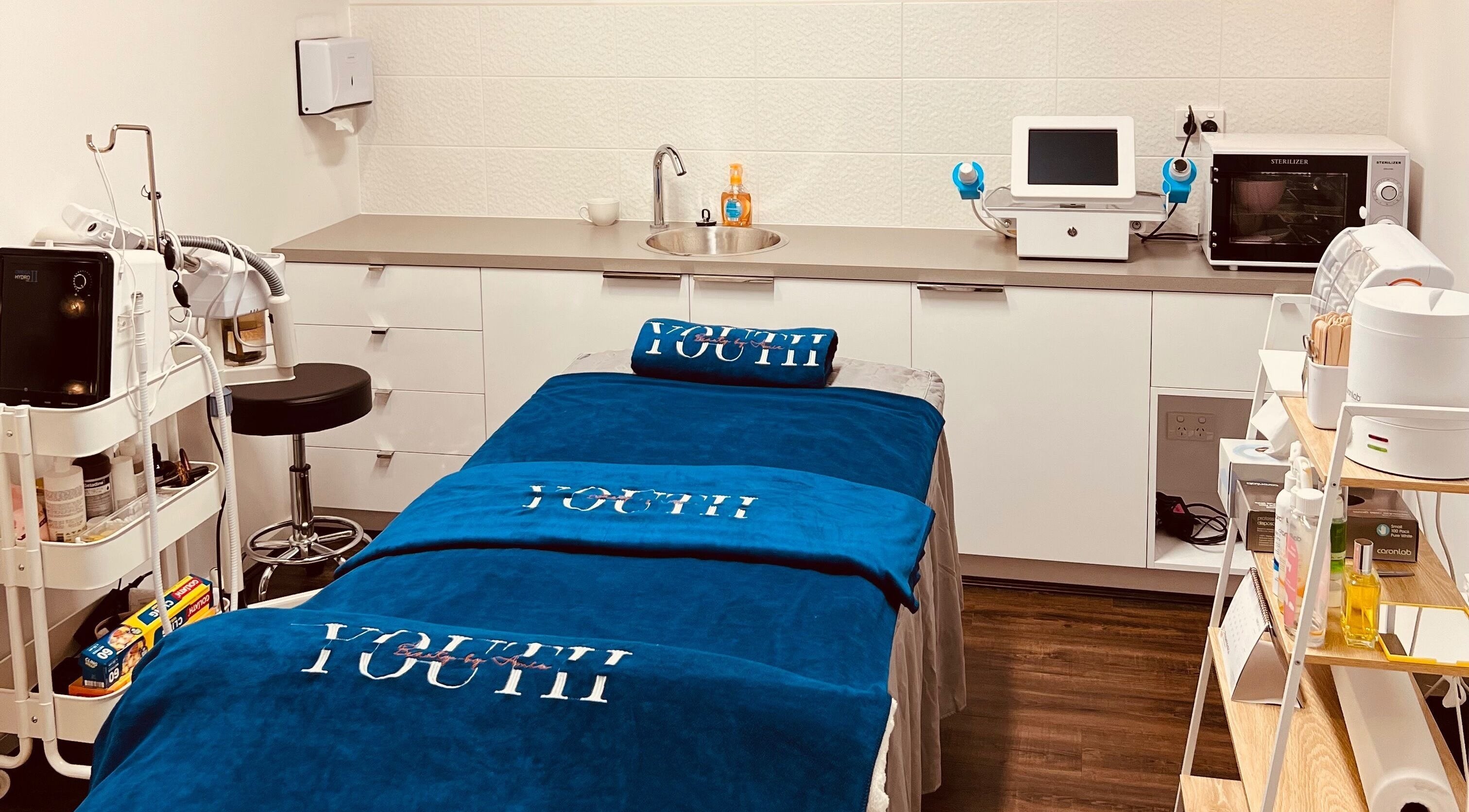 Treatment room in Youth Beauty by Amie, Melbourne, Victoria, AU with spa bed and equipment.