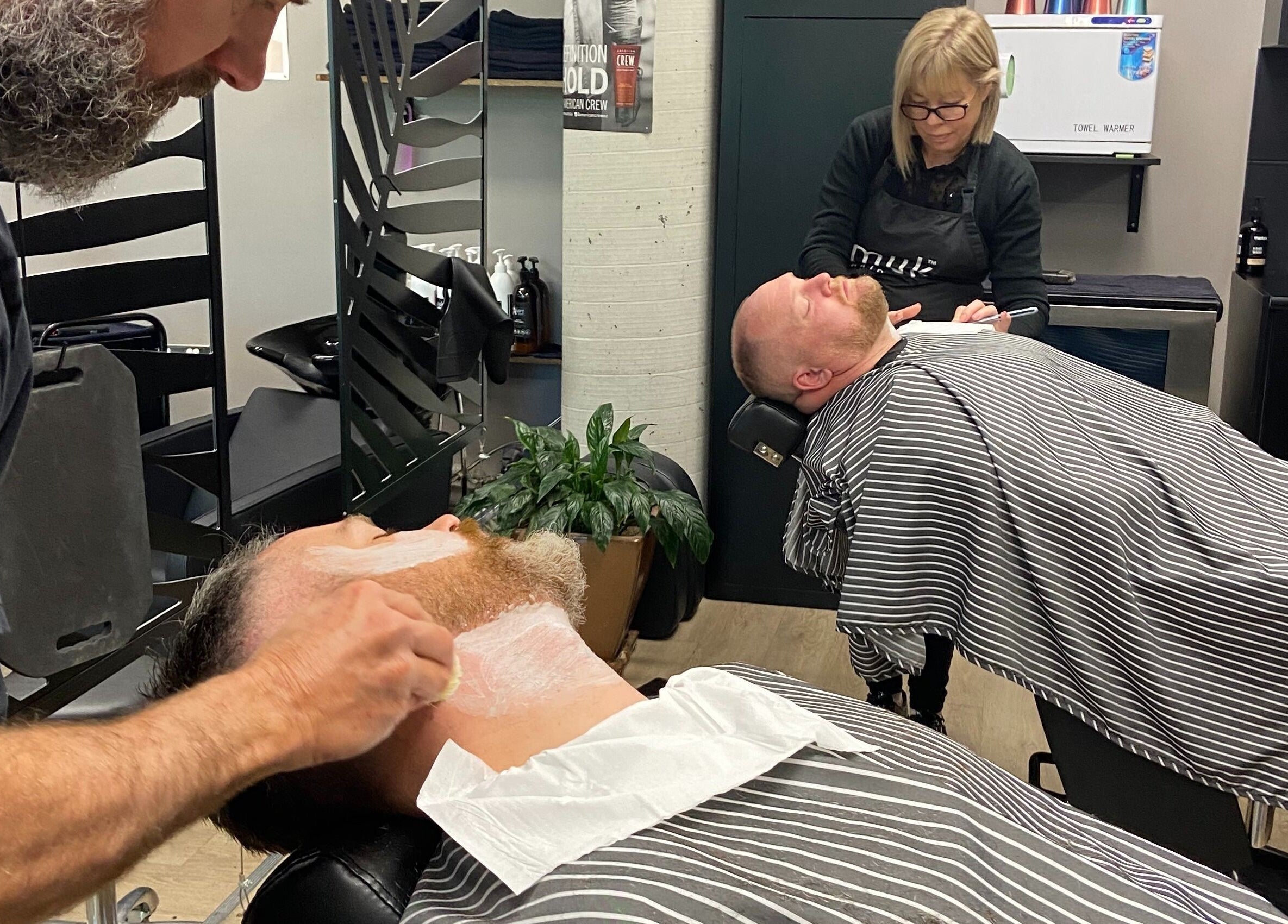 Relaxation at Thrones Barber and Stylists in Parkwood, Queensland, AU during a classic shave service.