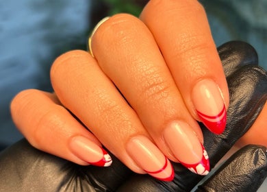 Red-tipped acrylic nails styled at The Brow & Nail Lounge, Worthing, England, GB.