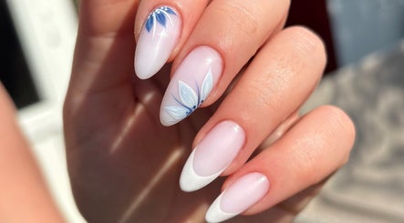 Elegant nail art with blue floral design at The Brow & Nail Lounge, Worthing, England, GB.