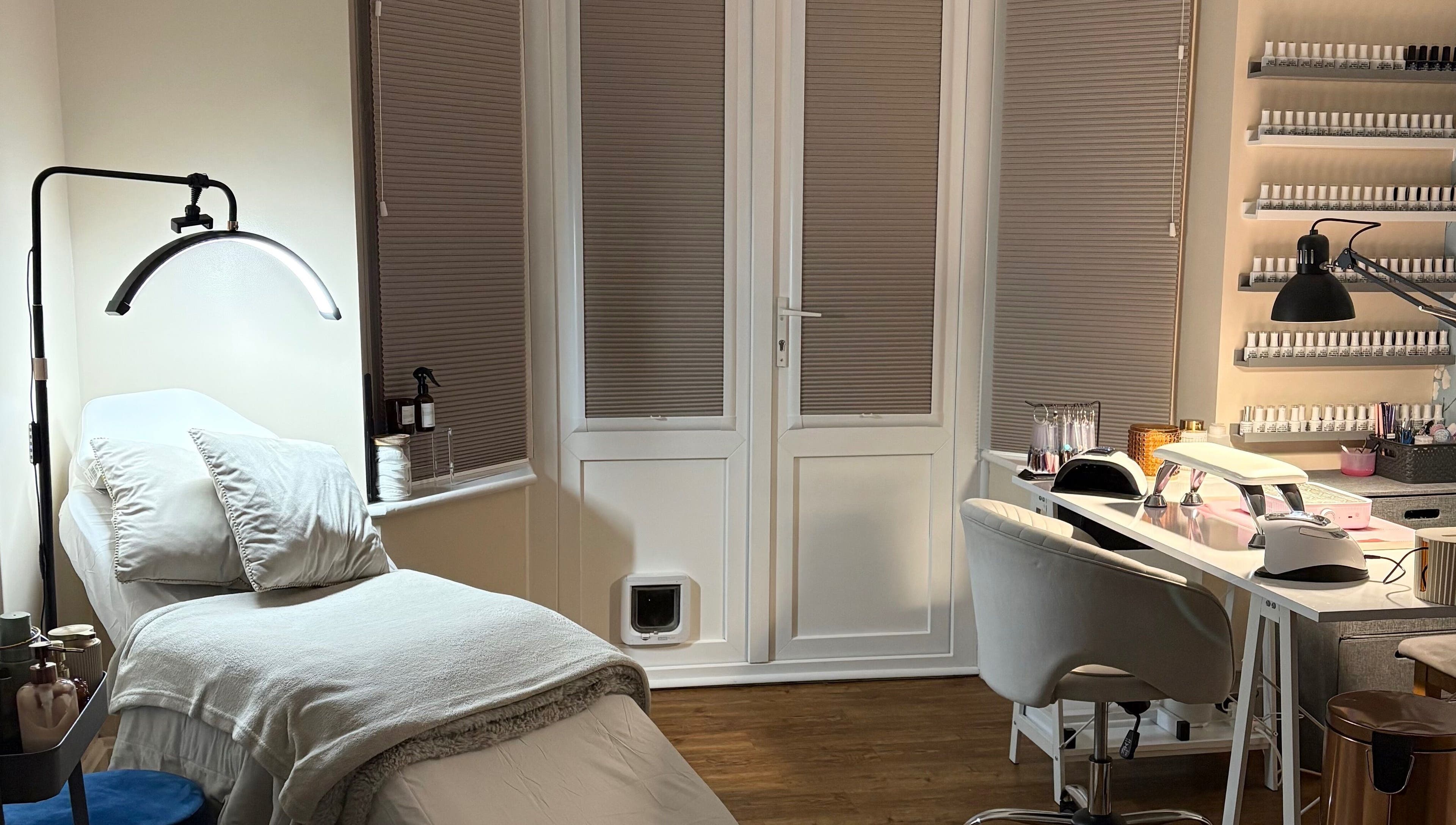 Relaxing interior of The Brow & Nail Lounge, Worthing, England, GB, featuring nail care station and treatment bed.