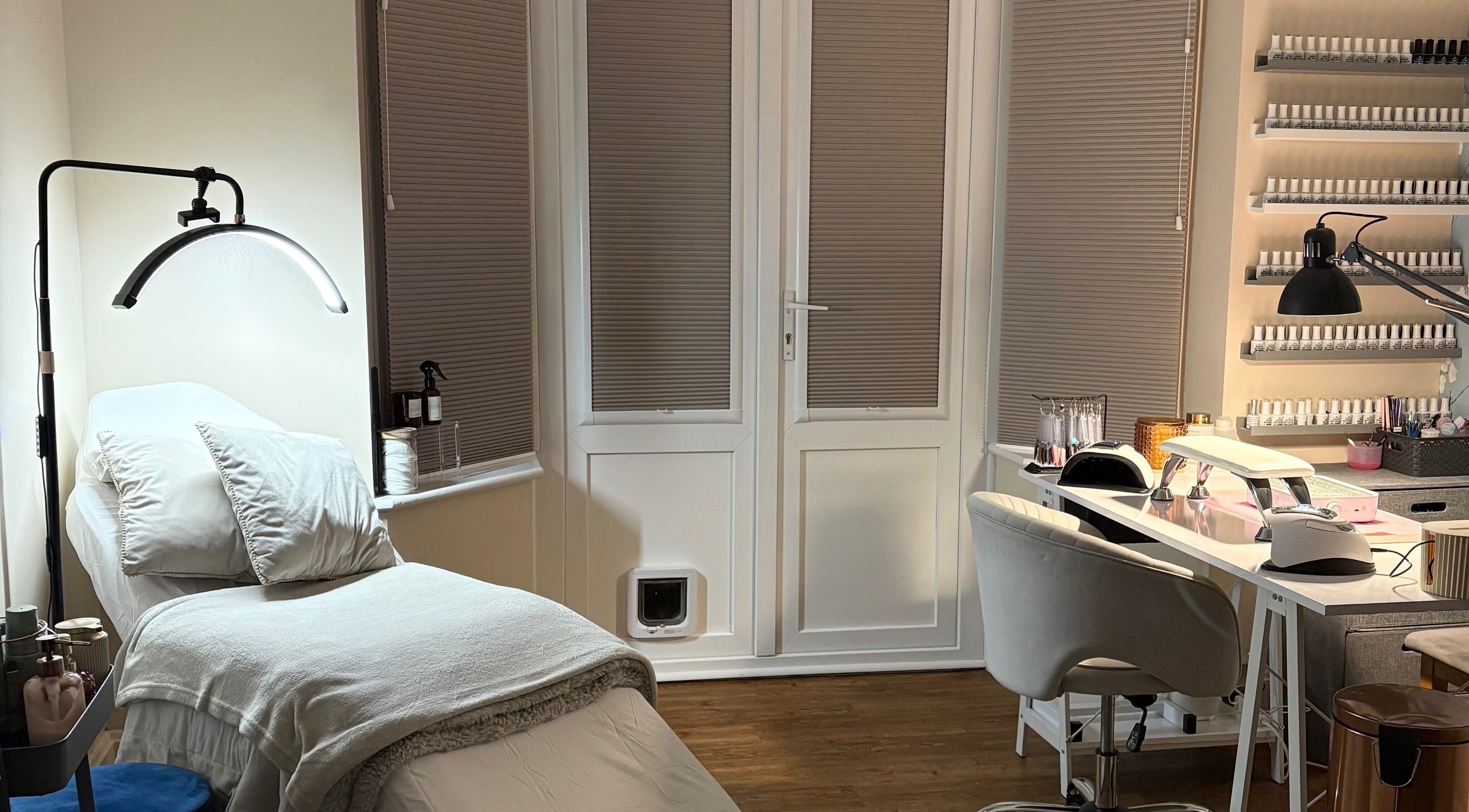 Relaxing interior of The Brow & Nail Lounge, Worthing, England, GB, featuring nail care station and treatment bed.