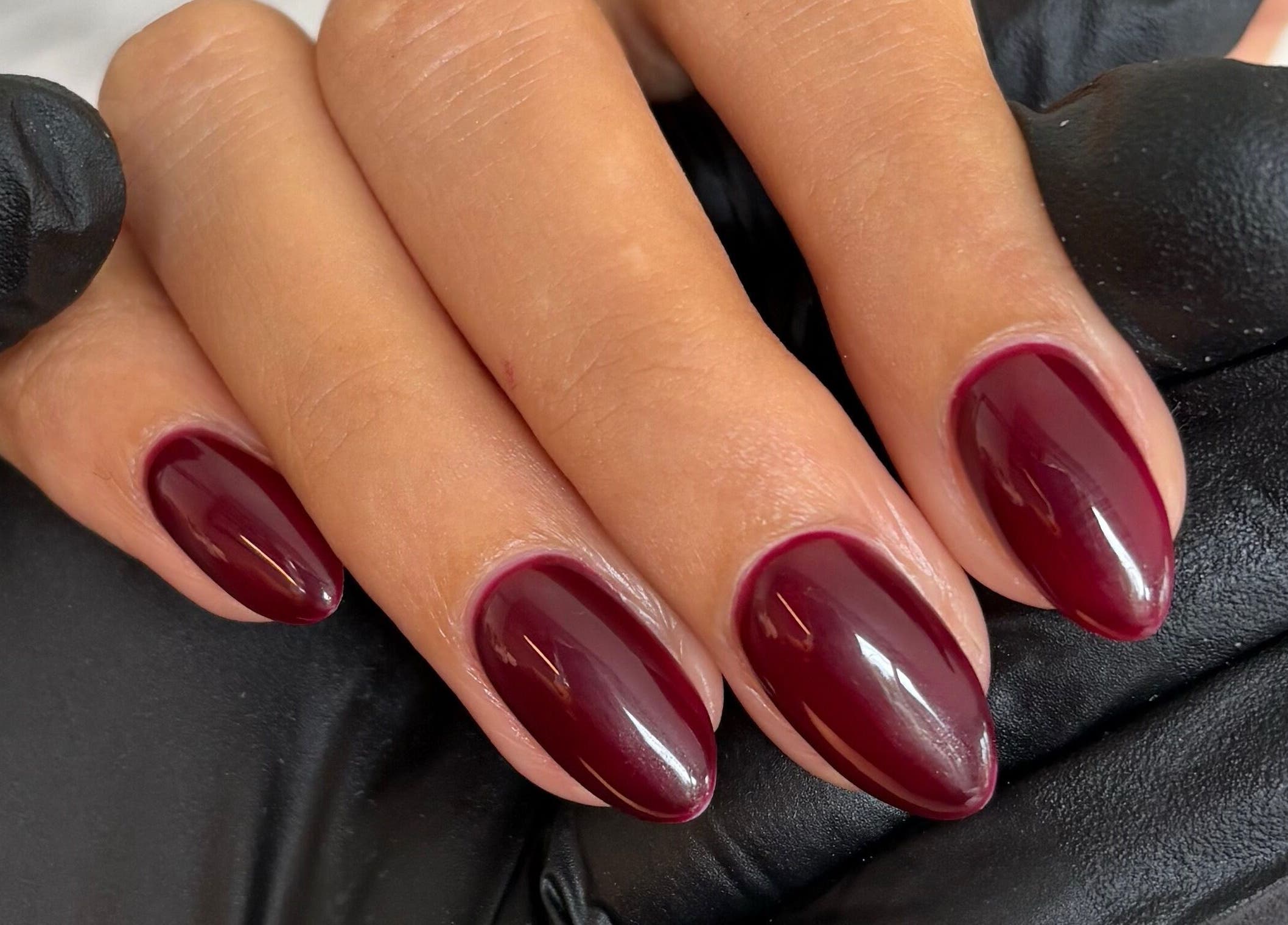 Burgundy manicured nails at The Brow & Nail Lounge, Worthing, England, GB.